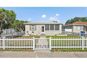 Charming home featuring a white picket fence, well-kept lawn, and quaint curb appeal at 918 27Th N St, St Petersburg, FL 33713