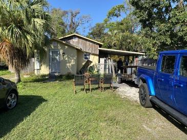Exterior view of home with lawn, mature trees, and vehicle parked in the driveway at 3512 16Th E St, Bradenton, FL 34208