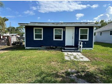 Charming blue home featuring a well-maintained lawn and a welcoming front entrance at 6039 81St N Ave, Pinellas Park, FL 33781