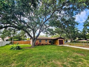 Charming single-story home with a large, mature tree providing ample shade and curb appeal at 7001 86Th N Ave, Pinellas Park, FL 33782