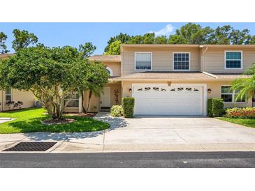 Charming townhouse featuring a two-car garage and well-maintained landscaping at 8980 Antigua Dr, Seminole, FL 33777