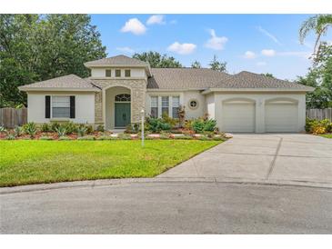 Charming single-story home with manicured lawn, inviting entrance, and two-car garage at 2901 Laurel Meadow Ct, Plant City, FL 33566