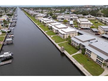 Scenic aerial view of waterfront condo community featuring boat docks and lush landscaping at 4812 Jasper Dr # 203, New Port Richey, FL 34652