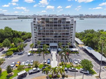An aerial view shows the building, parking and waterfront location on a sunny day at 500 N Osceola Ave # 811, Clearwater, FL 33755