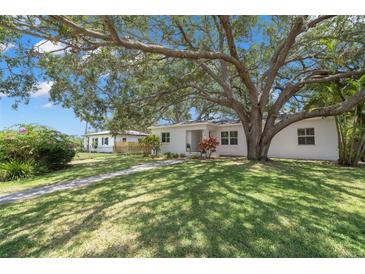 Charming single-story home with a lush green lawn and mature shade tree in a desirable neighborhood at 526 36Th Ne Ave, St Petersburg, FL 33704