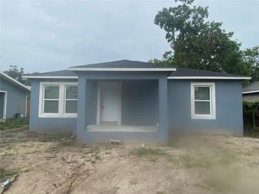 Charming single-story home with a covered porch and white-trimmed windows, showcasing its inviting curb appeal at 1108 11Th S Ave, St Petersburg, FL 33705