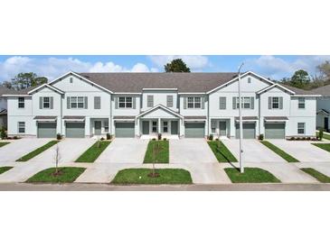 Charming townhomes feature private garages, driveways, and inviting landscaping enhancing curb appeal at 11742 Blackbrook Ct, Seffner, FL 33584