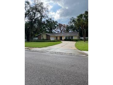 Charming single-story home with a well-maintained front yard and long driveway at 5281 Venetian Ne Blvd, St Petersburg, FL 33703