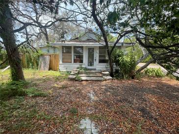 Charming home exterior with front porch and mature trees at 834 Grand Central St, Clearwater, FL 33756