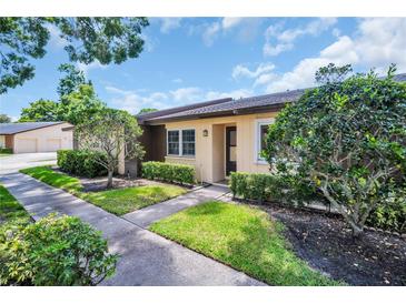 Charming home featuring well-maintained landscaping and a welcoming entrance with a tidy front yard at 860 Maclaren N Dr # A, Palm Harbor, FL 34684