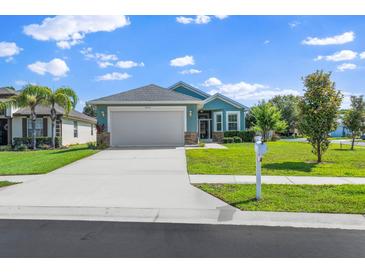 Charming single Gathering home with well-manicured lawn and two-car garage, situated on a sunny lot at 11016 Kiskadee Cir, New Port Richey, FL 34654