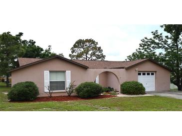 Charming single-story home with a well-manicured lawn and inviting curb appeal at 12488 Harper St, Spring Hill, FL 34609