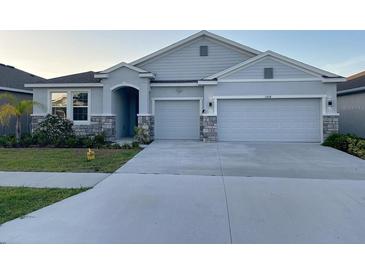 Charming single-Gathering home with a three-car garage and well-maintained landscaping at 13014 Willow Grove Dr, Riverview, FL 33579