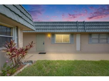 Charming home featuring a well-maintained front yard and a tranquil exterior view at dusk at 1802 Bedford Ter # 185, Sun City Center, FL 33573