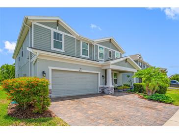 Charming two-story home features a manicured front yard, brick paved driveway, and a two-car garage at 4633 Ballantrae Blvd, Land O Lakes, FL 34638