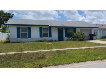 Charming single-story home with blue shutters and a well-maintained lawn at 2603 Mary Sue Sw St, Largo, FL 33774