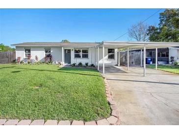 Charming one-story home with a well-manicured lawn and brick-lined landscaping at 3209 W Tyson Ave, Tampa, FL 33611