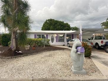 Charming single story home with lovely landscaping, a unique mailbox, and covered parking at 405 Bryn Mawr Is, Bradenton, FL 34207