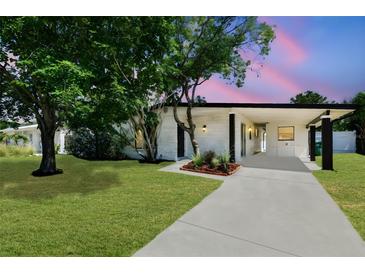 Charming single-story home with a well-manicured lawn and covered entryway, perfect for suburban living at 6551 S West Shore Cir, Tampa, FL 33616