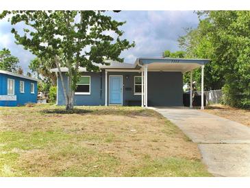 Cozy single-story home featuring a covered carport and a cheerful blue front door at 7307 34Th N Ave, St Petersburg, FL 33710
