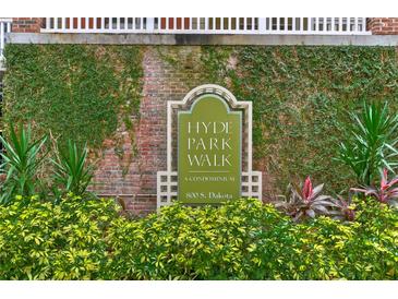 Hyde Park Walk condominium sign amidst lush greenery, showcasing the property's welcoming entrance and established community at 800 S Dakota Ave # 429, Tampa, FL 33606
