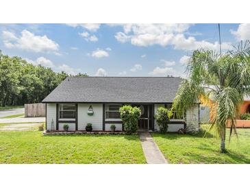 Charming single-story home featuring manicured landscaping and a welcoming entrance at 16023 Splitlog Dr, Tampa, FL 33618