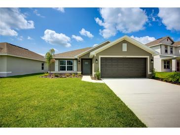 Charming single-Gathering home featuring a well-manicured lawn, and a two-car garage at 16503 66Th E Ln, Parrish, FL 34219