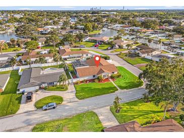 Waterfront home featuring lush landscaping, mature trees, and circular driveway in a desirable neighborhood with access to the bay at 2006 Tanglewood Ne Dr, St Petersburg, FL 33702
