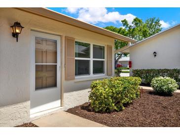 Charming single-story home featuring a well-maintained front garden with green bushes and a welcoming entrance at 3146 37Th S Ln # A, St Petersburg, FL 33711