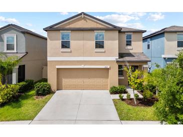 Inviting two-story home showcasing a well-maintained lawn and an attached two-car garage at 4403 Eternal Prince, Sun City Center, FL 33573