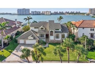 Beautiful waterfront home with lush landscaping and a spacious three-car garage in a tropical paradise at 5287 61St S Ave, St Petersburg, FL 33715