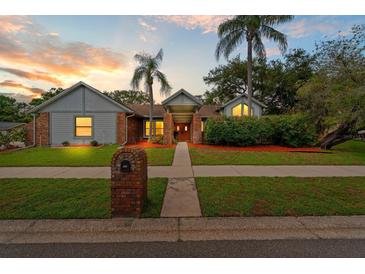 Charming single-story home featuring a well-manicured lawn, brick accents, and mature landscaping with beautiful curb appeal at 625 Fayette S Dr, Safety Harbor, FL 34695