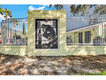 Exterior community sign for Art Center Lofts in St. Petersburg, Florida, featuring unique design and gated fence at 1501 Doyle Carlton Dr # 303, Tampa, FL 33602