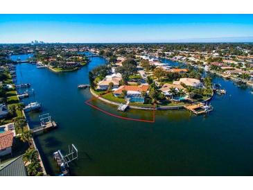 Waterfront property with a pool and dock on a sunny day showcasing the expansive canal views at 2096 Massachusetts Ne Ave, St Petersburg, FL 33703