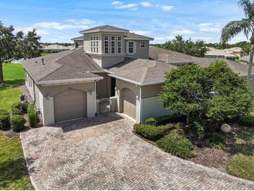 Stunning two-story home with a tile roof and a brick paved driveway and two-car garage at 2490 Kensington Greens Dr # 0, Sun City Center, FL 33573