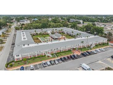 An aerial view of the condominium building with a pool and parking at 4748 Azalea Dr # 204, New Port Richey, FL 34652