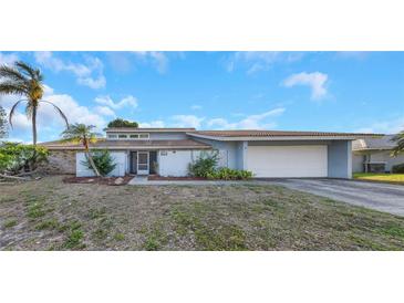Charming single-story home with a two-car garage, tile roof, and low-maintenance landscaping at 605 Citrus Ct, Largo, FL 33770