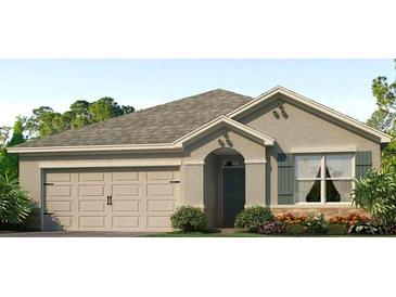 Charming one-story home featuring a neutral color scheme and an attached two-car garage at 7696 Wheat Stone Dr, Zephyrhills, FL 33540