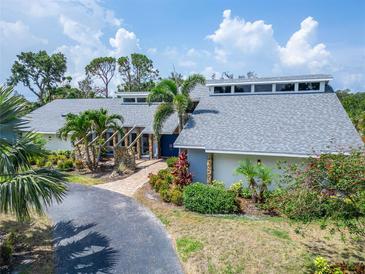 Stunning home featuring beautiful landscaping, a brick walkway, and a striking blue double door entry at 7815 16Th Nw Ave, Bradenton, FL 34209