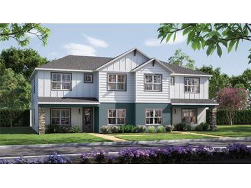 Charming two-story duplex with stone accents, white siding, and well-maintained landscaping at 10705 Wading River Ave, Parrish, FL 34219
