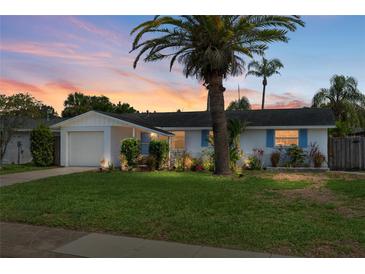 Charming single-story home with lush lawn, mature landscaping, and attached garage at 12359 82Nd N Ave, Seminole, FL 33772