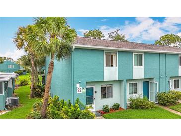 Inviting two-story home with a blue exterior, complemented by a well-manicured lawn at 147 114Th Ne Ave # 147, St Petersburg, FL 33716