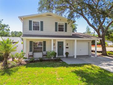 Charming two-story home with lush landscaping, a covered entrance, and a well-maintained front yard at 150 Bosphorous Ave, Tampa, FL 33606