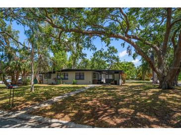 Charming single-story home with a lush, tree-filled front yard, offering shade and curb appeal at 1501 Howard Pl, Largo, FL 33770
