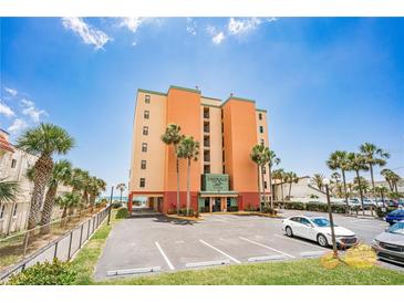 Charming multi-story building with palm trees and a parking lot in a sunny coastal setting at 17334 Gulf Blvd # 203, North Redington Beach, FL 33708