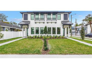 Striking modern two-story home featuring black window accents and a meticulously manicured front yard at 2812 N Massachusetts Ave, Tampa, FL 33602