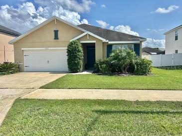Charming single-story home with a well-maintained lawn, beautiful landscaping, and a two-car garage at 3313 San Moise Pl, Plant City, FL 33567
