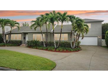 Charming single Gathering home featuring a neatly manicured lawn, lush landscaping, and a two car garage at 333 30Th N Ave, St Petersburg, FL 33704