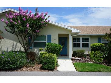 Charming home exterior featuring a well-maintained lawn, vibrant landscaping, and inviting front entrance at 413 Lake Point Ct # 4B, Sun City Center, FL 33573