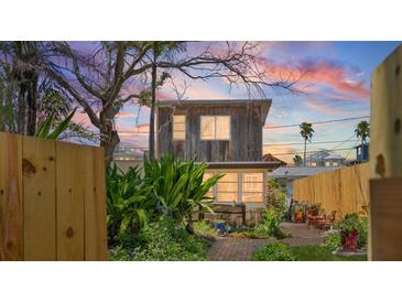 Charming two-story home with lush landscaping and unique architectural details at 44 77Th Ave, Treasure Island, FL 33706